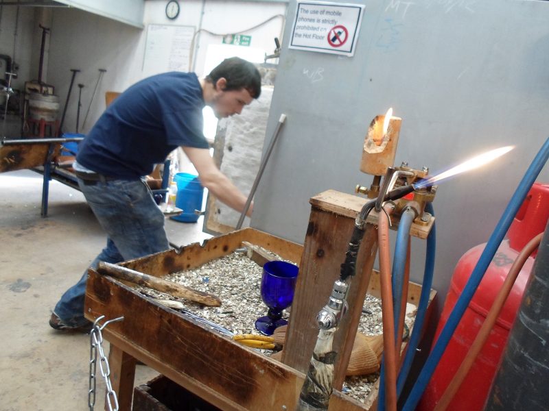 Showing the area where the glass is taken from the iron and the bunson burner they use