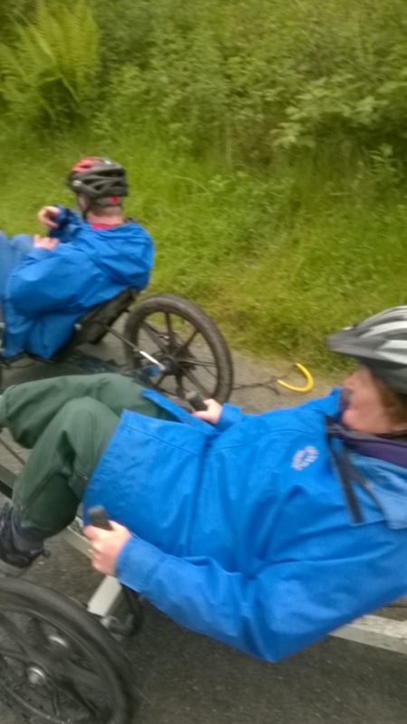 Andrew and Jean racing downhill on their Recumbent Bikes.