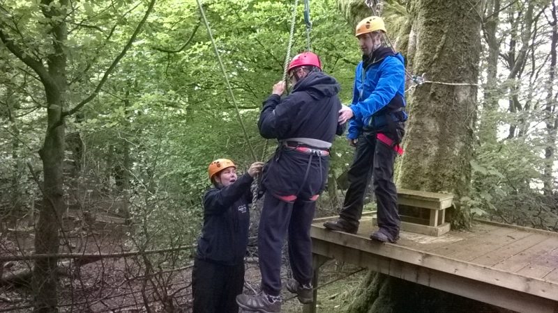 Low ropes in the forest. This was an amazing challenge. Charlotte and Alun helping James, our first volunteer,  onto  the the wire. We had to balance on the galvanised wire, hold onto the rope, if we could find it, and move along the wire by finding the next rope in line. A lot of movement on the wire and wobbling whilst trying to catch hold of the ropes. Exciting and fun!