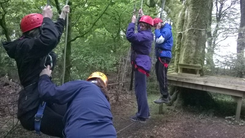 Charlotte helping Su;  Jean and Spud have joined the in the task. I forgot to say there were three people on the wire at the same time. What fun!