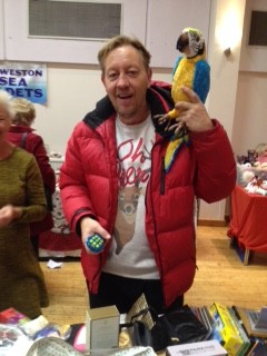 The gentleman who bought the parrot for his granddaughter. He seems very pleased.