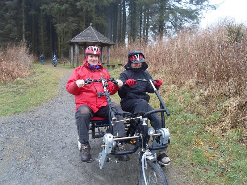 Spud and Su riding around the reservoir on the bikes