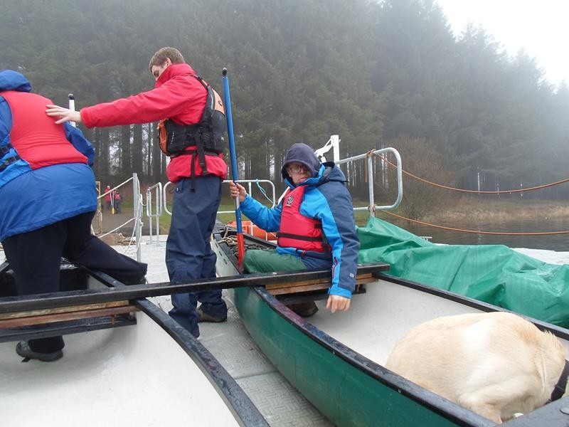 Alun helping Jayne into the canoe. James supervising!