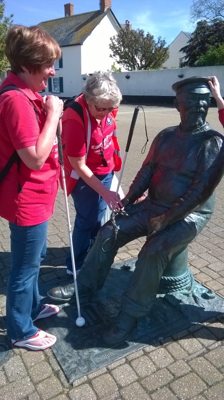 Jean and Ann, touching the artwork, of Yankee Jack. Very tactile sculpture