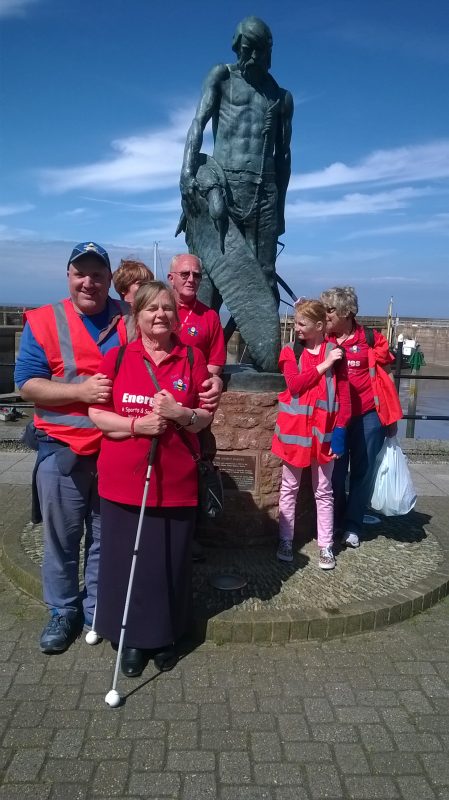 John, Julie, Jean, Bryan, Sarah and Ann stood in front of the statue of The Ancient Mariner on Watchet's Harbour front