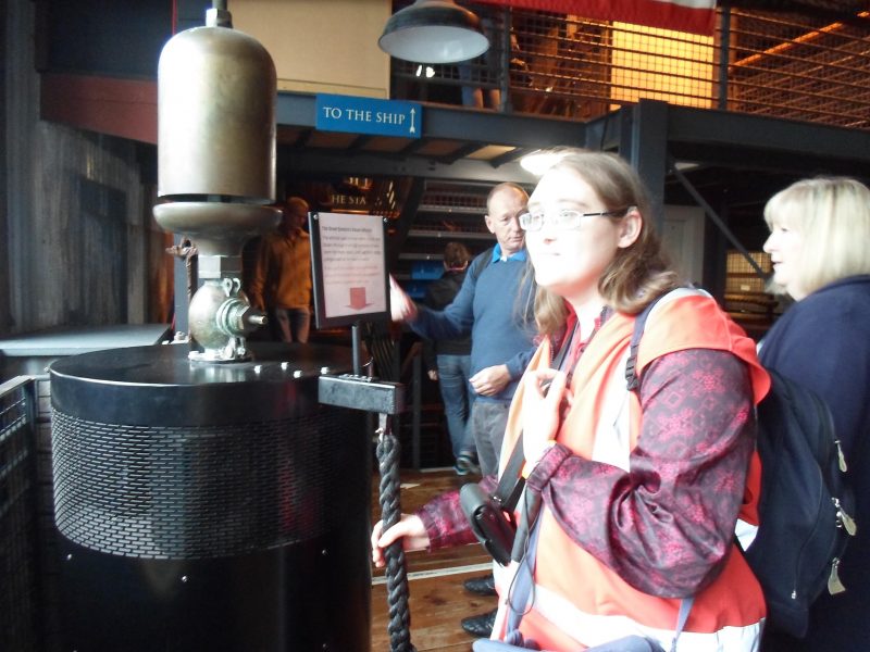 Kimby pulling the lever to sound the ship's funnel