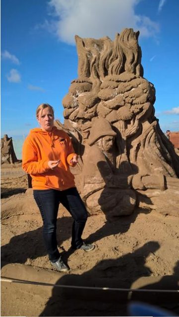 CAROLINE, OUR LOVELY GUIDE, STOOD BY THE SCULPTURE FIRE FIGHTER, carved by Sergi Ramirez from Spain.