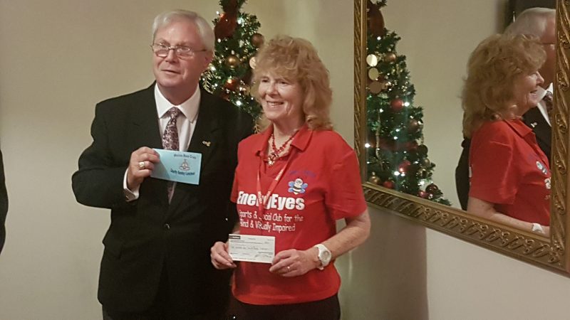 ALAN JONES PRESENTING A CHEQUE TO AILEEN, ENERGEYES'S CHAIRMAN