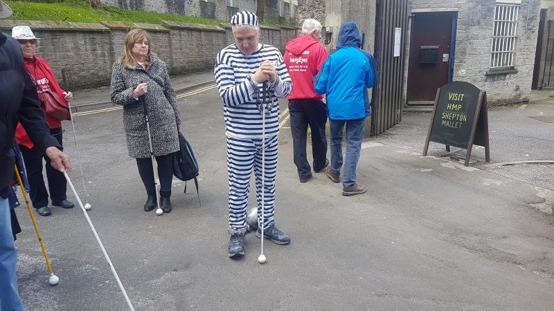 JULIE, JOHN, SPUD, JAMES AND ANN IN THE COURTYARD OUTSIDE THE PRISON