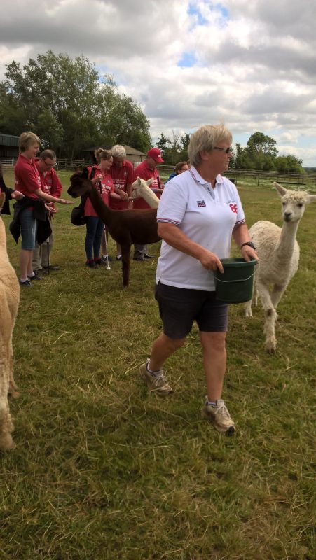 Kim, in the white t-shirt, has the food in the bucket