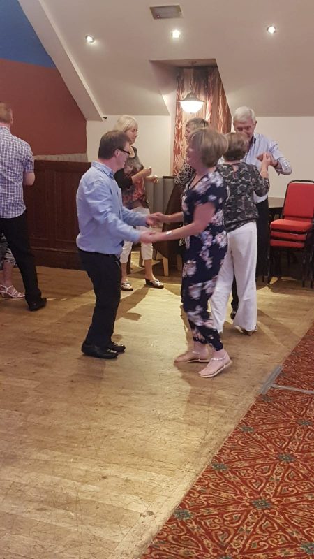 PAUL WITH HIS BACK TO US ALL, ANDREW DANCING WITH JEAN, SPUD WITH PAM, SU AND TESS IN BACKGROUND.