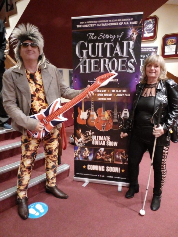 ROCK STAR AND ROCK CHICK STOOD BY THE POSTER IN THE PLAYHOUSE THEATRE,  WESTON-SUPER-MARE