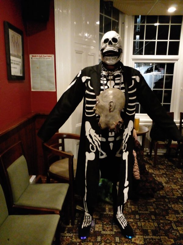 JOHN HOLDING A HALLOWEEN SKULL