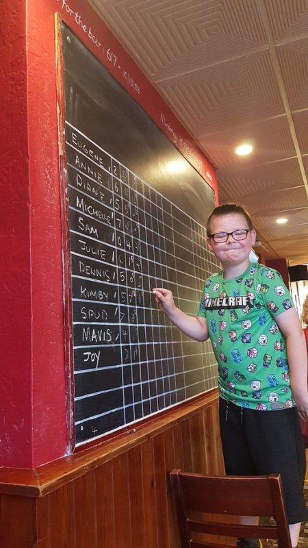 SAM WRITING THE SCORES ON THE BOARD