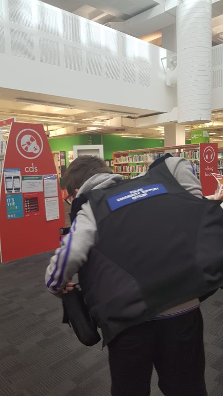 SAM WEARING THE OFFICERS JACKET, SHOWING THE WRITING ON THE BACK