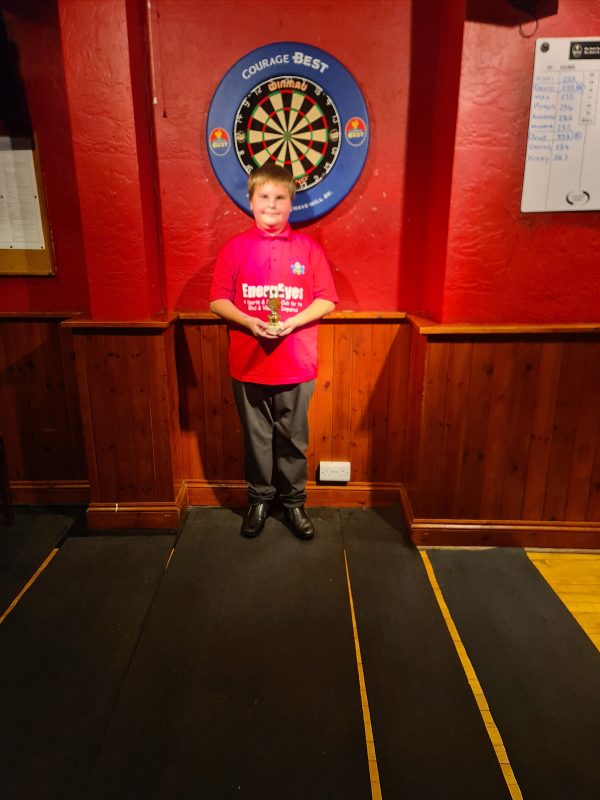 MAX OUR NEW VOLUNTEER HOLDING THE DARTS TROPHY