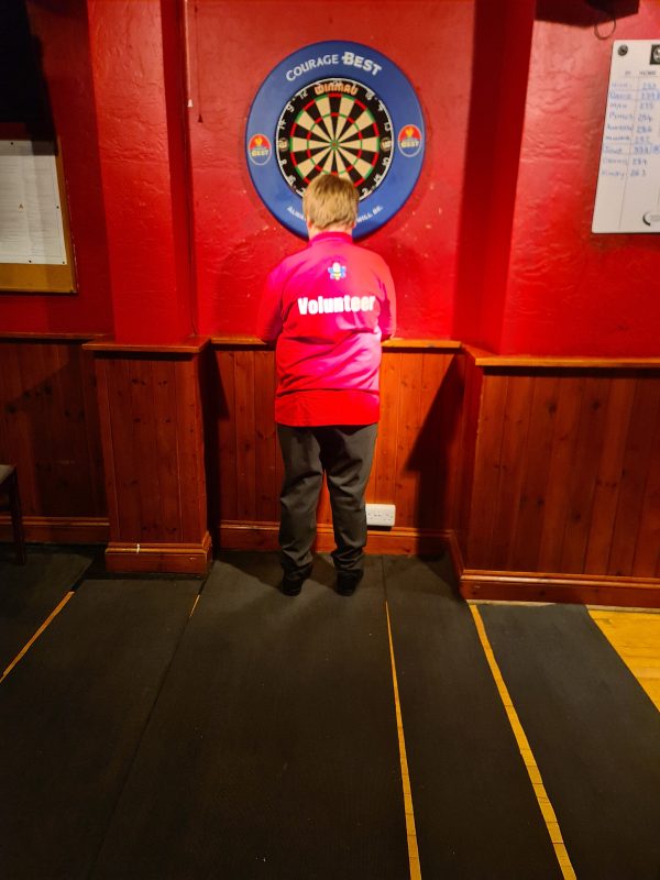 MAX SHOWING HIS VOLUNTEER LABEL ON THE BACK OF HIS POLO SHIRT